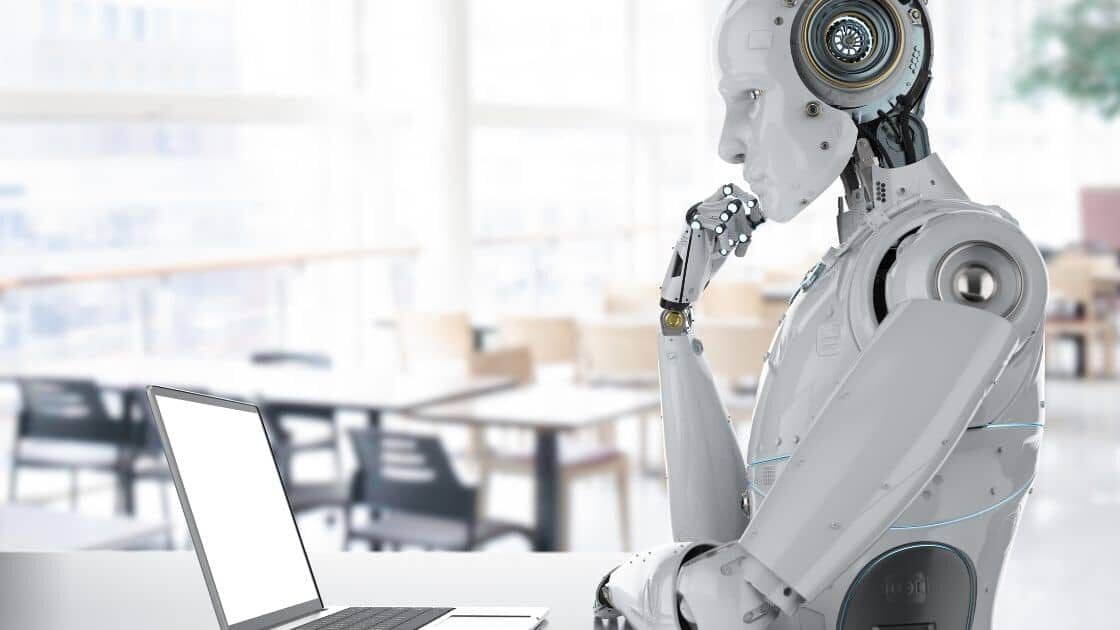 A humanoid AI-Powered robot writing content on a computer